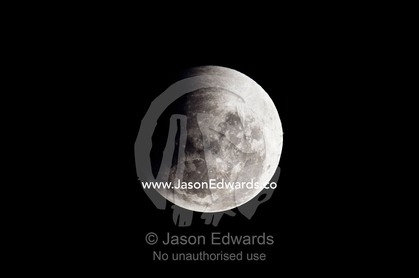 A shadow passes across the face of a full moon during an eclipse. Carlton North, Melbourne, Victoria, Australia.