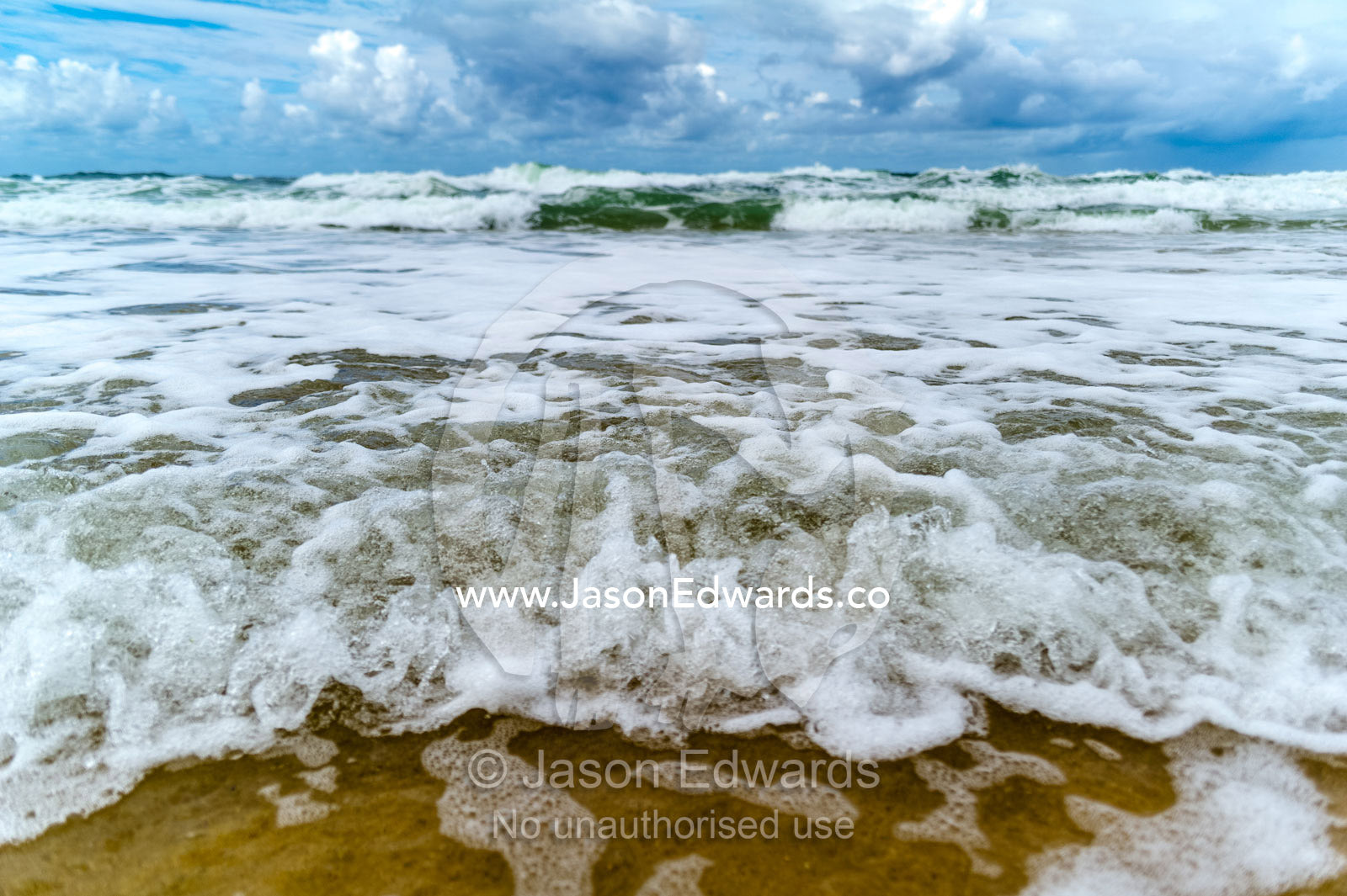 Storm surge waves rolling onto an empty beach. Point Arkwright, Yaroomba Beach, Queensland, Australia.