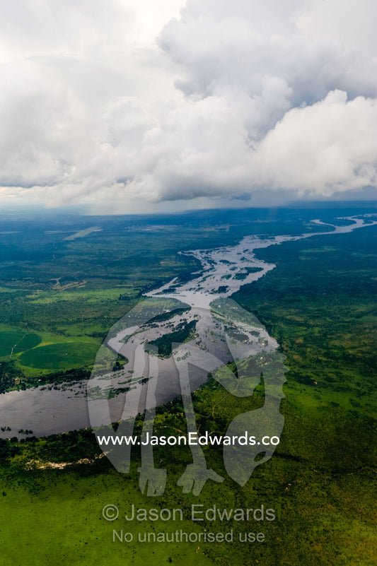 The mighty Zambezi River flowing through a lush savannah plain. Zambezi River, Mosi-oa-Tunya National Park, Zambia. Zambia-Zimbabwe Border.