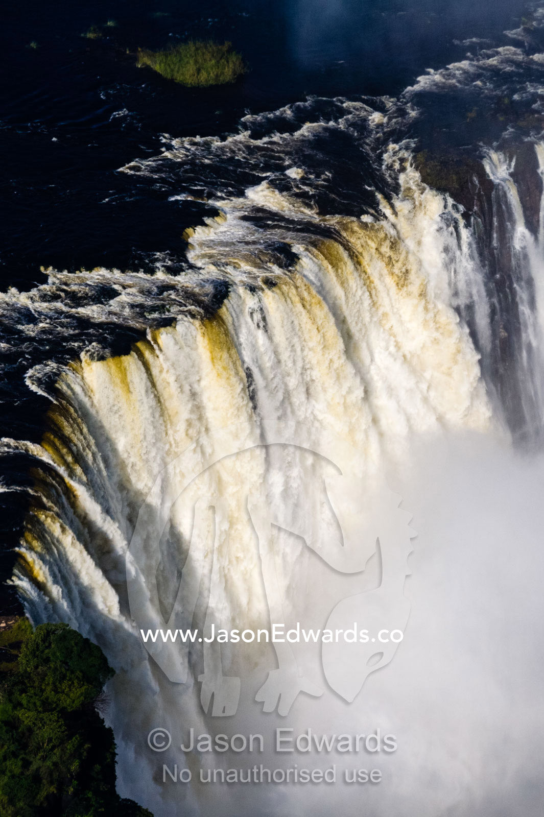 Torrents of water from the Zambezi River cascade over Victoria Falls into the chasm at the Devil's Cataract. Zambezi River, Victoria Falls, Mosi-oa-Tunya National Park, Zambia.