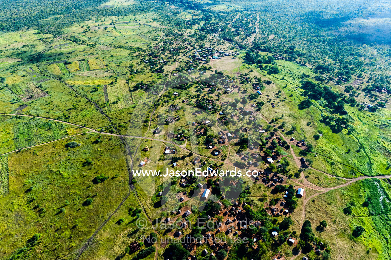 Small subsistence farms surround a village on a green plain near the Zambezi River. near Victoria Falls, Zimbabwe.
