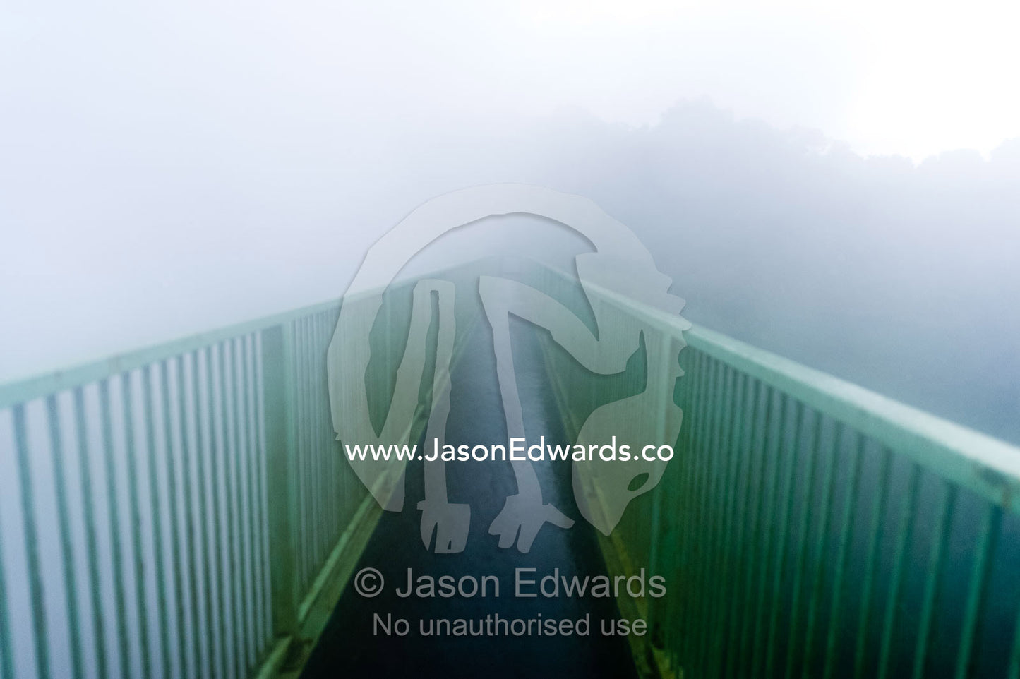 Mist shrouds a foot bridge spanning a gorge at Victoria Falls. Victoria Falls, Mosi-oa-Tunya National Park, Zambia.