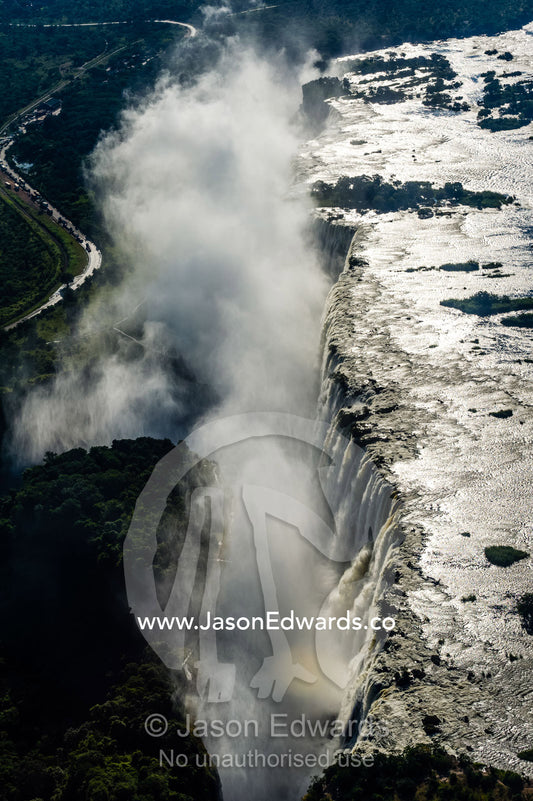 Torrents of water from the Zambezi River cascade over Victoria Falls into the chasm at First Gorge. Zambezi River, Victoria Falls, Mosi-oa-Tunya National Park, Zambia.