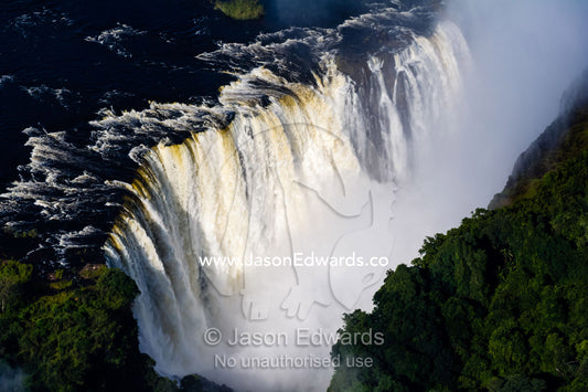 Torrents of water from the Zambezi River cascade over Victoria Falls into the chasm at the Devil's Cataract. Zambezi River, Victoria Falls, Mosi-oa-Tunya National Park, Victoria Falls National Park, Zambia.