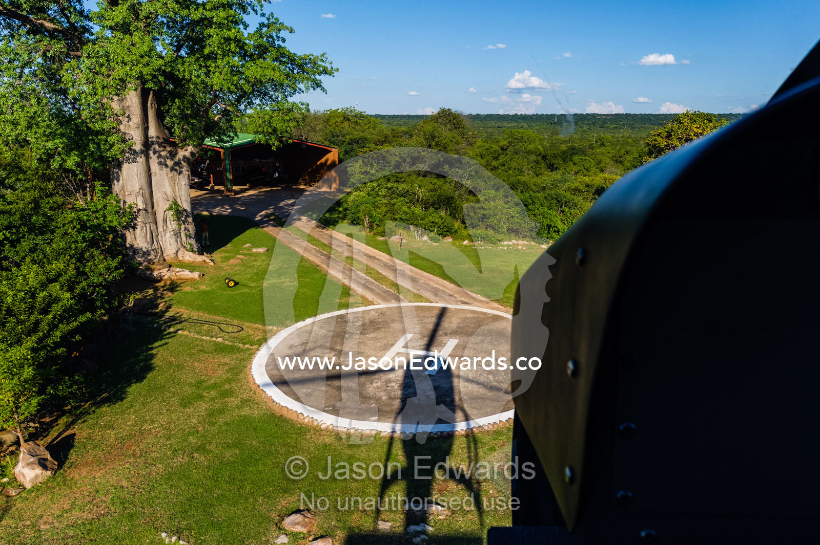 The shadow of a helicopter landing on a helipad. Zambezi Sun Hotel, Victoria Falls, Zambia.