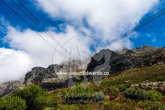 Cable car cables rising to the summit of Table Mountain. Table Mountain, Cape Town, Western Cape, South Africa.