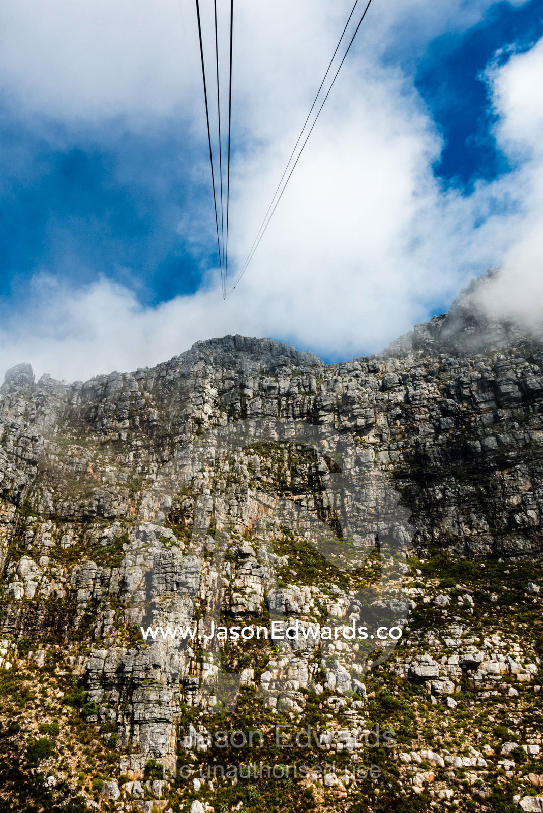 Cable car cables rising to the summit of Table Mountain. Table Mountain, Cape Town, Western Cape, South Africa.