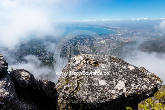 An aerial view of Cape Town suburbs and Table Bay from the summit of Table Mountain. Table Mountain, Cape Town, Western Cape, South Africa.