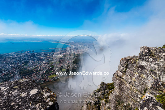 An aerial view of Cape Town suburbs and Table Bay from the summit of Table Mountain. Table Mountain, Cape Town, Western Cape, South Africa.