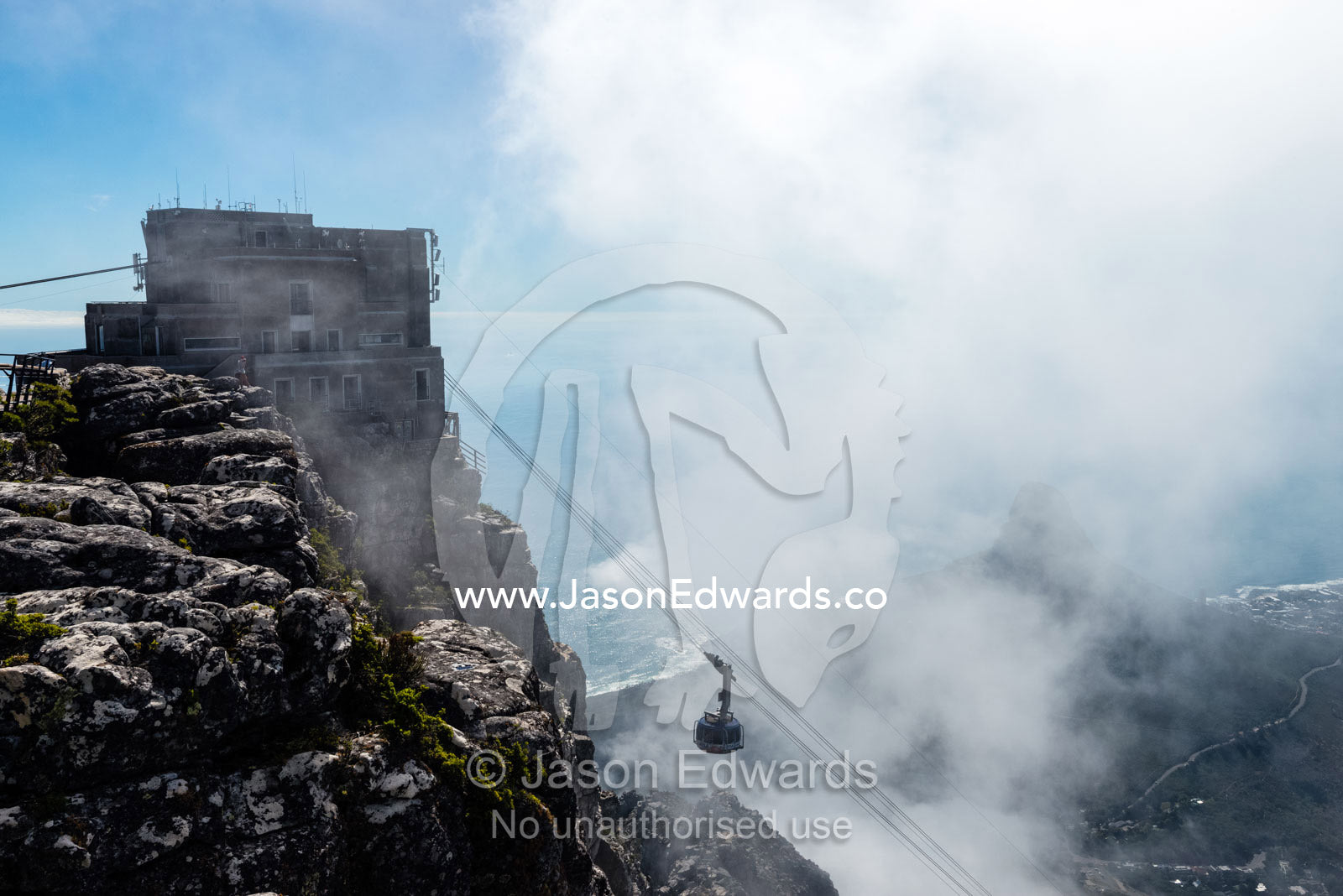A cable car rises to the summit of Table Mountain through a cloud bank. Table Mountain, Cape Town, Western Cape, South Africa.