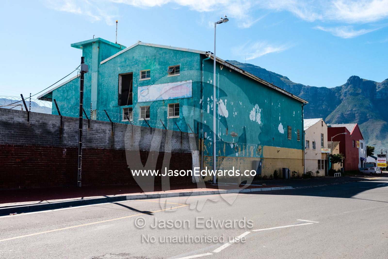 Abandoned factories and industry in a coastal town. Hout Bay, Cape Town, Chapmans Peak Drive, Western Cape, Cape Peninsula, South Africa.