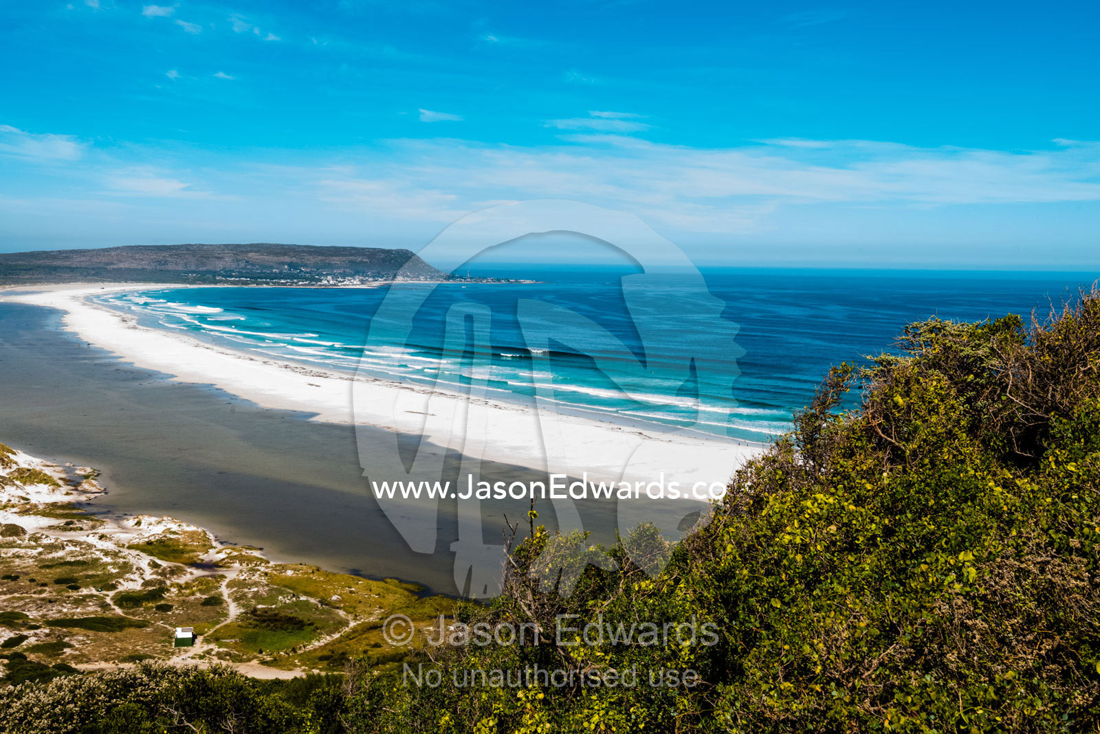 A wide sweeping ocean beach hidden among sand dunes. Noordhoek Beach, Cape Town, Chapmans Peak Drive, Western Cape, South Africa.