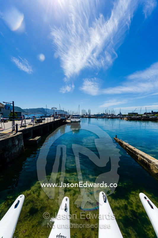 The bows of sea kayaks moored at a wharf. Simon's Town Naval Base, Cape Town, False Bay, Cape Peninsula, Chapmans Peak Drive, Western Cape, South Africa.
