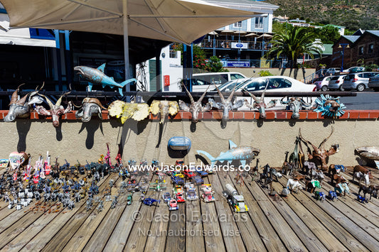 An artist displays his metal sculptures made from car parts on a jetty. Simon's Town Naval Base, Cape Town, False Bay, Cape Peninsula, Chapmans Peak Drive, Western Cape, South Africa.