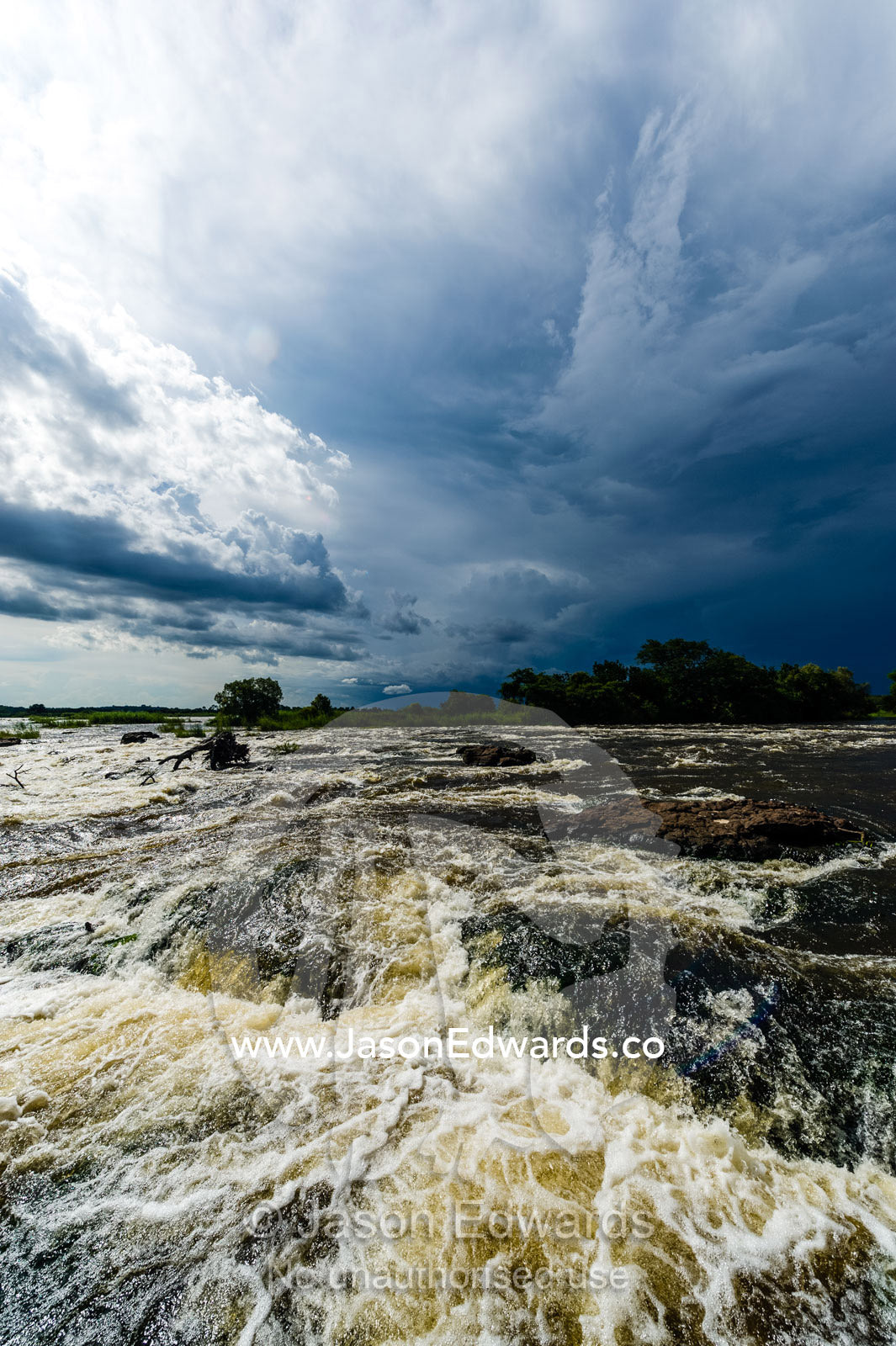 The raging current of the Zambezi River after heavy rain falls. Zambezi River, Victoria Falls, Mosi-oa-Tunya National Park, Zambia.