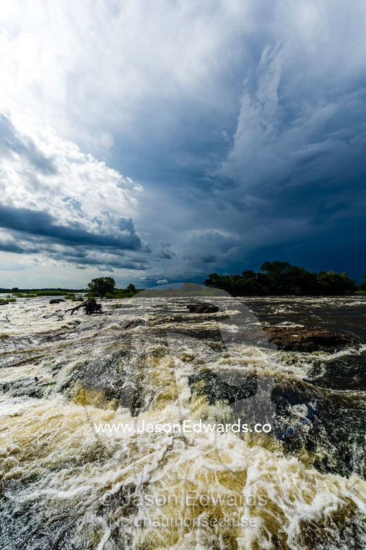 The raging current of the Zambezi River after heavy rain falls. Zambezi River, Victoria Falls, Mosi-oa-Tunya National Park, Zambia.