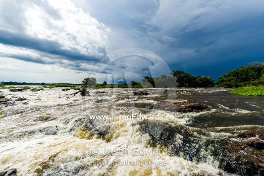 The raging current of the Zambezi River after heavy rain falls. Zambezi River, Victoria Falls, Mosi-oa-Tunya National Park, Zambia.