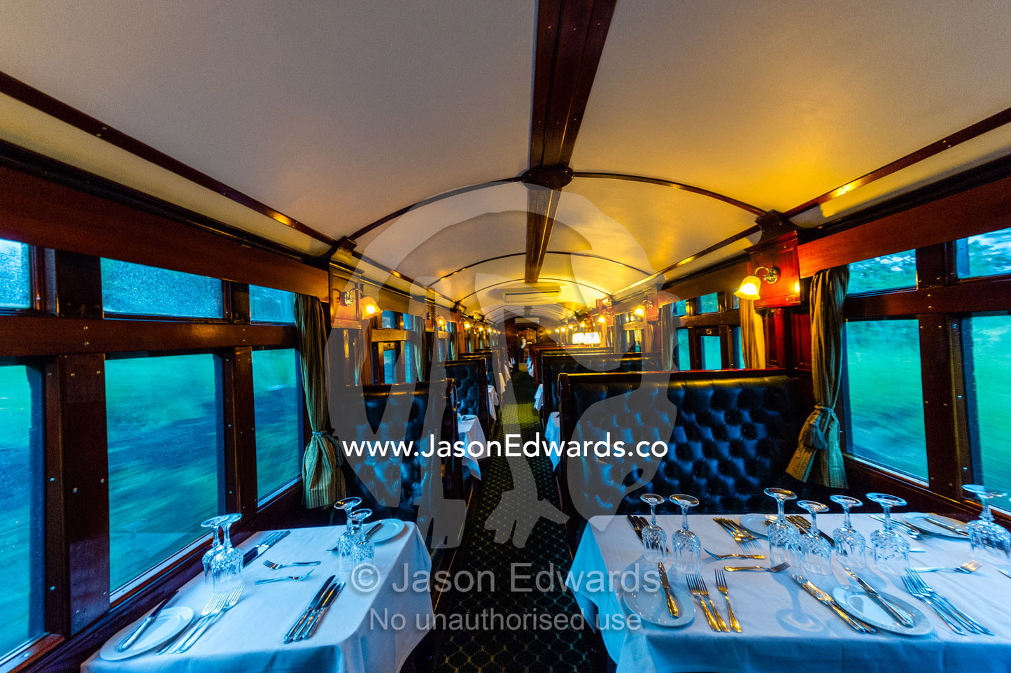 The First Class dining car of an antique steam train replete with silver service. Livingstone, Zambia.