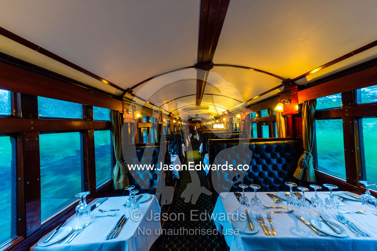 The First Class dining car of an antique steam train replete with silver service. Livingstone, Zambia.