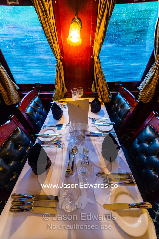 The First Class dining car of an antique steam train replete with silver service. Livingstone, Zambia.