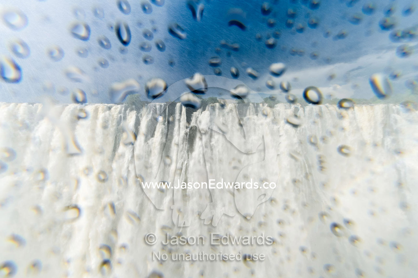 The view of Victoria Falls through a lens covered in water droplets. Zambezi River, Victoria Falls, Mosi-oa-Tunya National Park, Zambia.