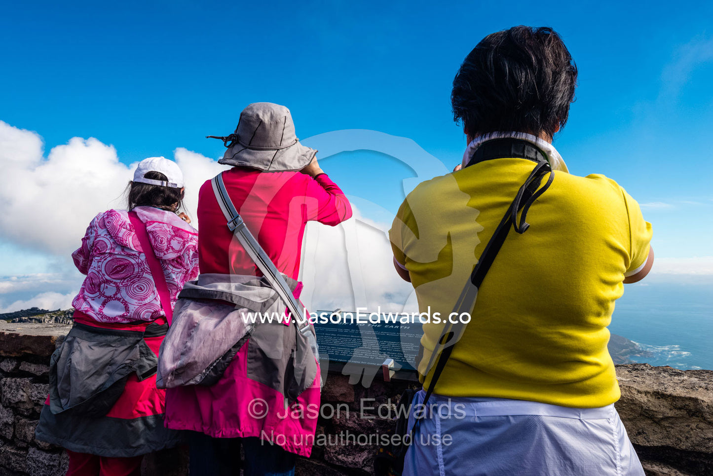 Asian tourists photographing Cape Town from the summit of Table Mountain. Table Mountain, Cape Town, Western Cape, South Africa.