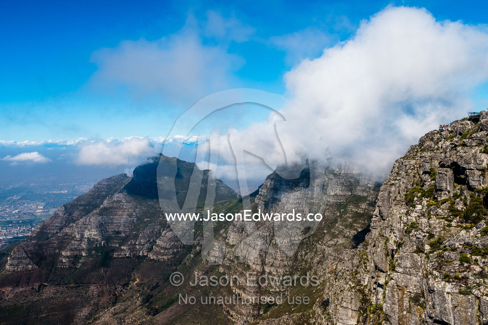 Clouds gather above the summit of Table Mountain with its sheer cliffs. Table Mountain, Cape Town, Western Cape, South Africa.