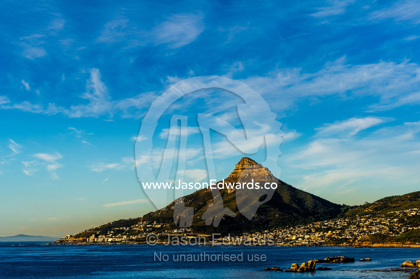 Sunset falls on Cape Town and the Lion's Head overlooking Table Bay. Lion's Head, Cape Town, Western Cape, South Africa.
