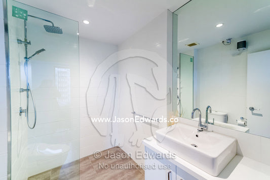 A modern bathroom wash basin and shower in an inner city apartment. St Kilda, Melbourne, Victoria, Australia.