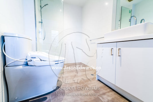 A modern bathroom wash basin and shower in an inner city apartment. St Kilda, Melbourne, Victoria, Australia.