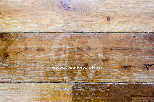 A textured detail of polished floorboards in an apartment. St Kilda, Melbourne, Victoria, Australia.