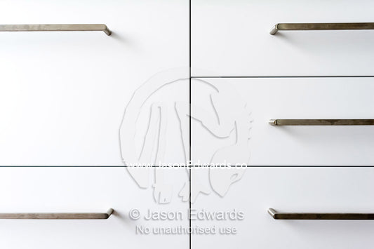 The joinery and handles on kitchen draws in an inner city apartment. St Kilda, Melbourne, Victoria, Australia.
