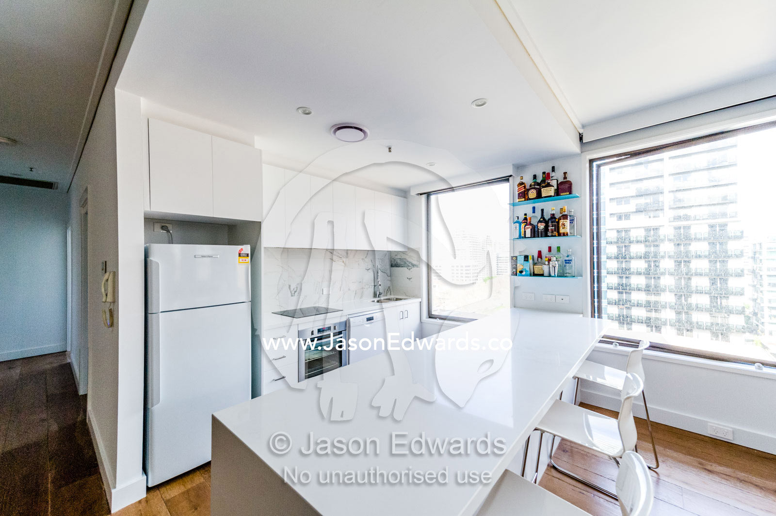 A clean white kitchen in an inner city apartment. St Kilda, Melbourne, Victoria, Australia.