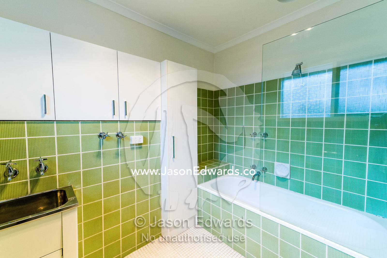 A tiled bathroom and laundry in an inner city apartment. Brunswick, Melbourne, Victoria, Australia.