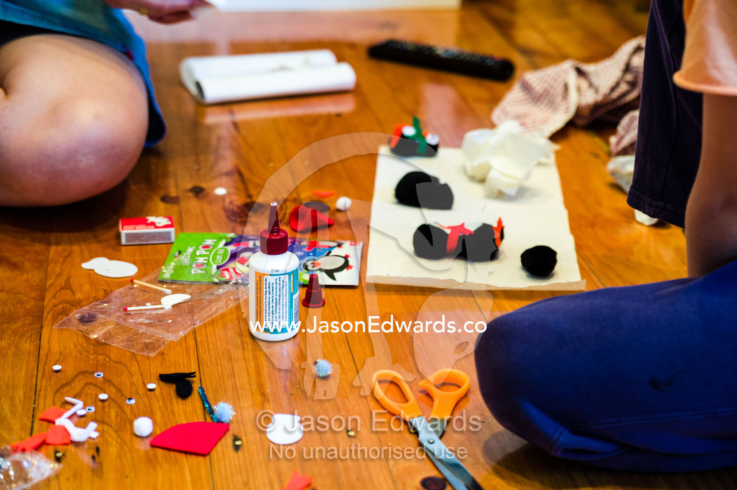 A mother and son make decorations for a Christmas tree. Carlton North, Melbourne, Victoria, Australia.