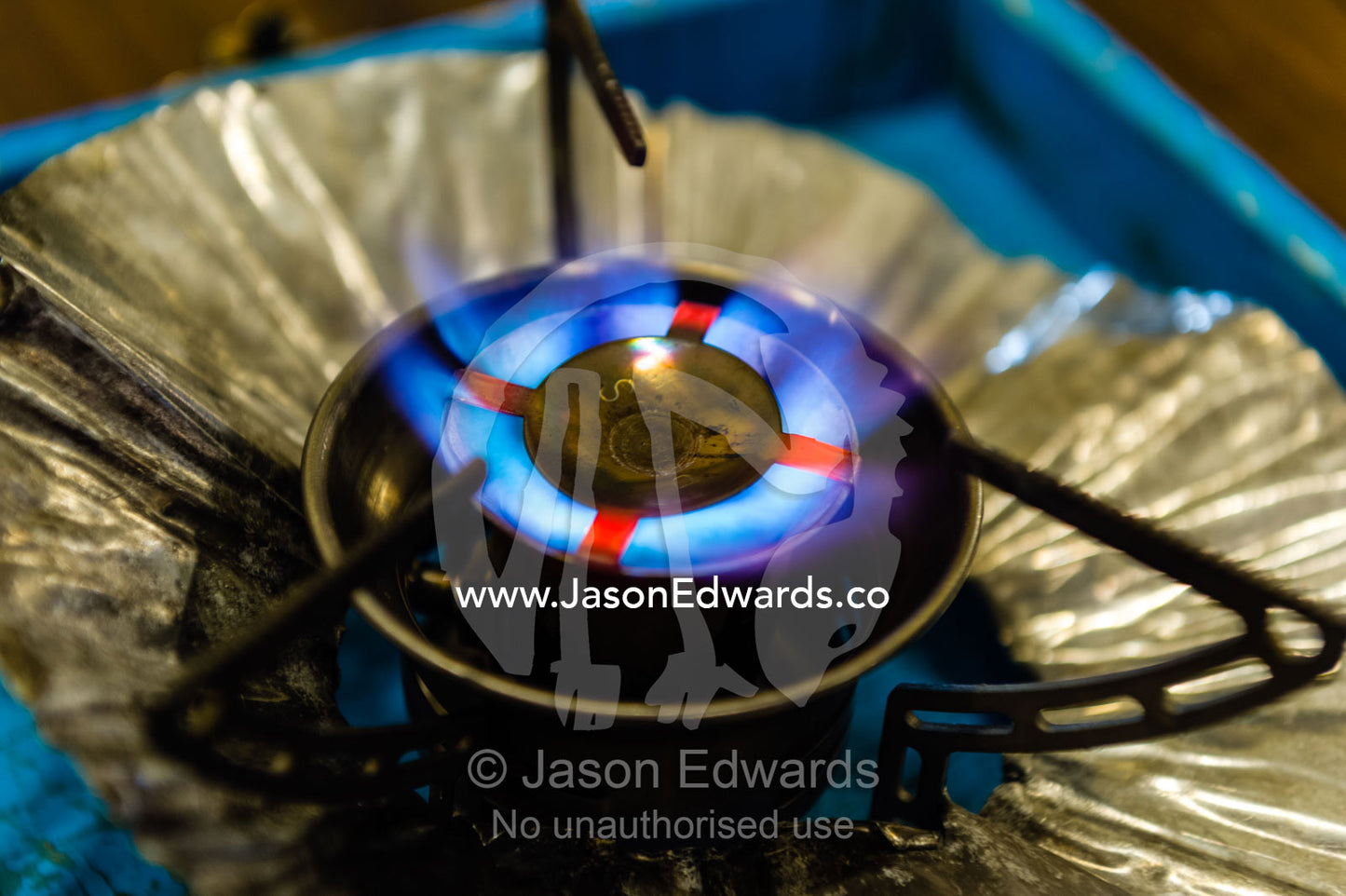 A blue gas flame emerging from jets in an Antarctic camping cooker. Scott Base, Pram Point, Hut Point Peninsula, Ross Island, Antarctica