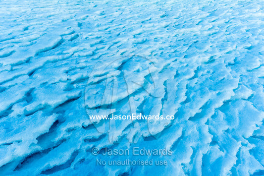 Brittle windblown plates of ice on the slopes of a mountain in Antarctica. Castle Rock, Ross Island, Antarctica