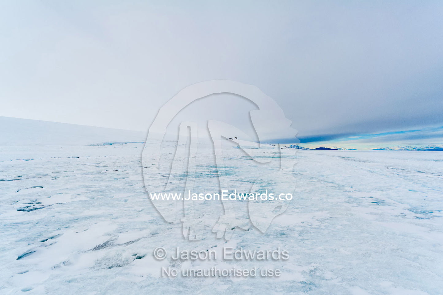 Snow drifts gather on the sea ice in Antarctica. Turtle Rock, Erebus Bay, McMurdo Sound, Ross Island, Antarctica