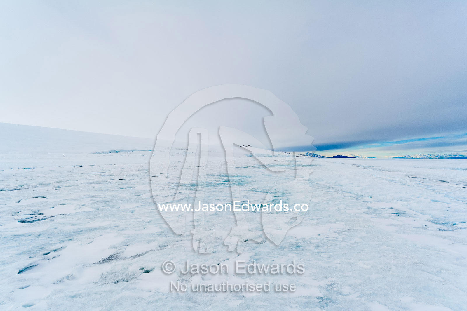 Snow drifts gather on the sea ice in Antarctica. Turtle Rock, Erebus Bay, McMurdo Sound, Ross Island, Antarctica