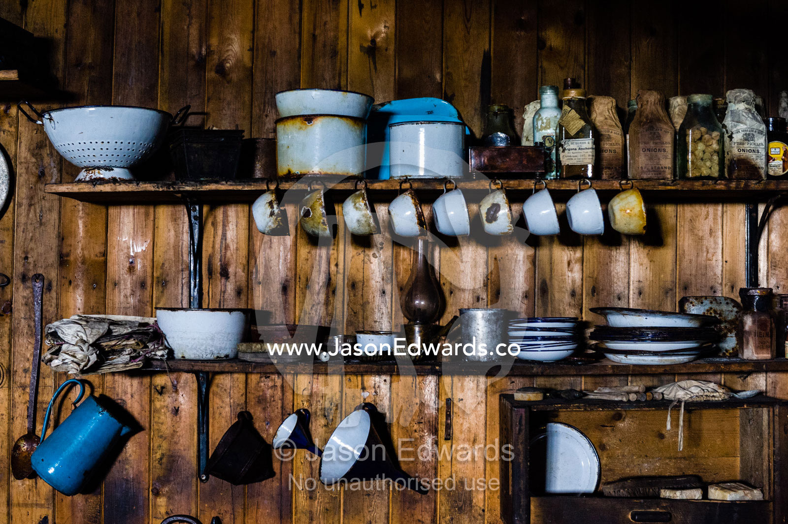 Plates, cups and kitchen utensils in the hut of Antarctic explorer Robert Falcon Scott. Scott's Hut, Cape Evans, Ross Island, Antarctica.