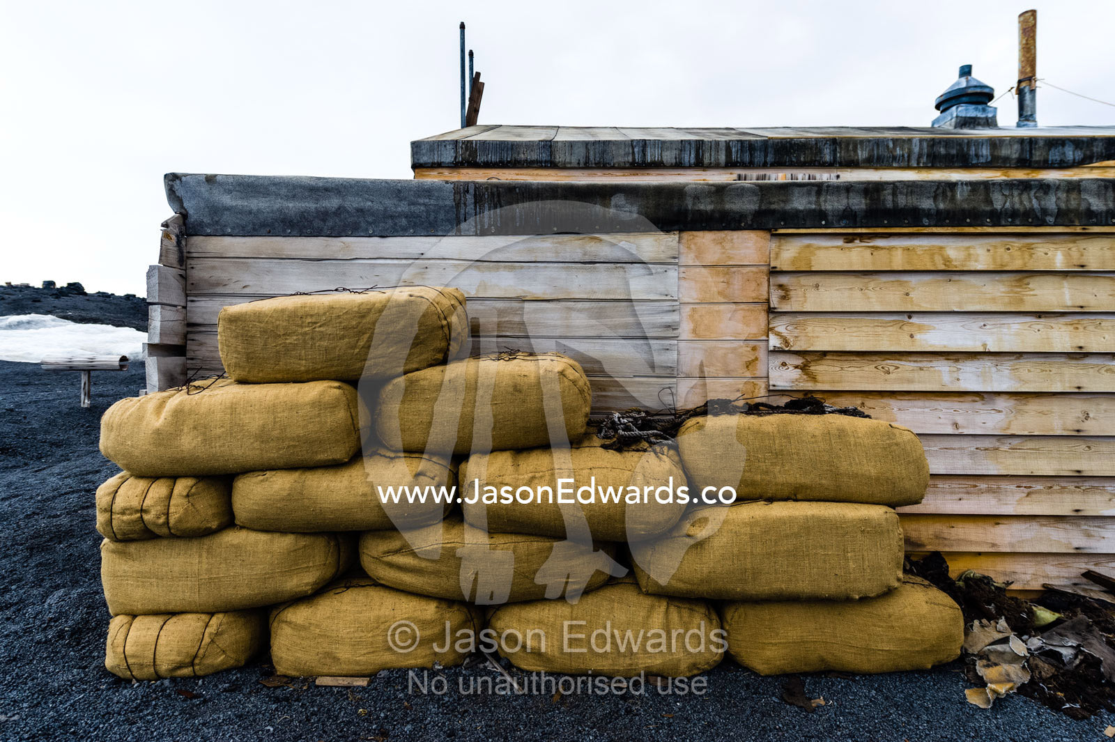 Hay bales to feed horses stacked against the wall of Antarctic explorer Robert Falcon Scott's hut. Scott's Hut, Cape Evans, Ross Island, Antarctica.