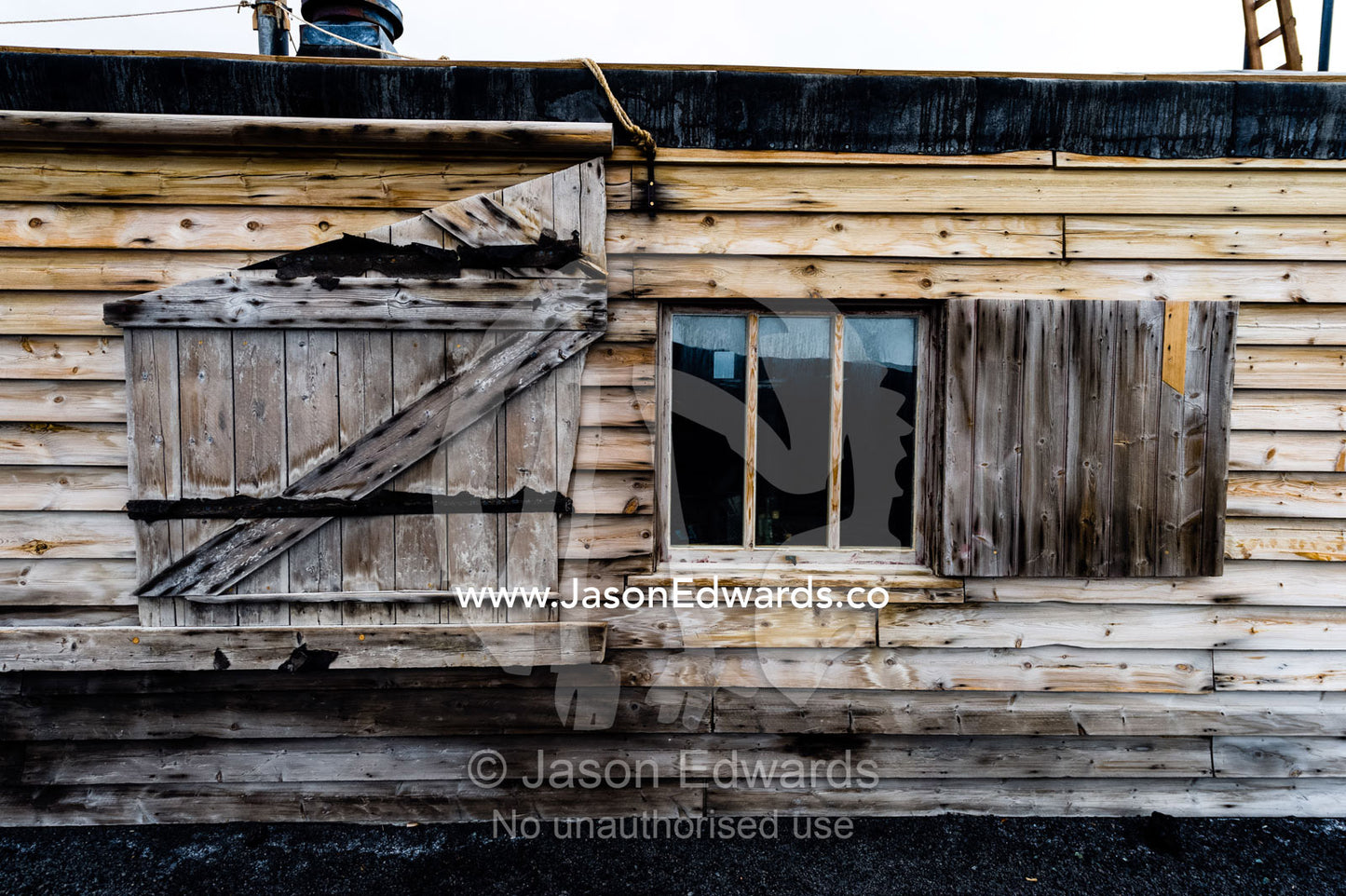 The weathered walls and window shutters of the Antarctic explorer Robert Falcon Scott's hut. Scott's Hut, Cape Evans, Ross Island, Antarctica.