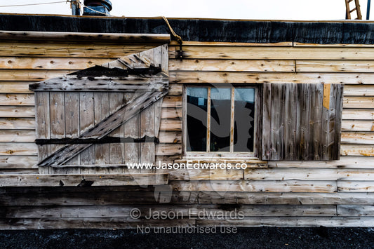 The weathered walls and window shutters of the Antarctic explorer Robert Falcon Scott's hut. Scott's Hut, Cape Evans, Ross Island, Antarctica.
