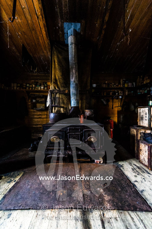 The inside of Antarctic explorer Ernest Shackleton's hut with its large stove, food supplies and bed bunks. Shackleton's Hut, Cape Royds, Ross Island, Antarctica.