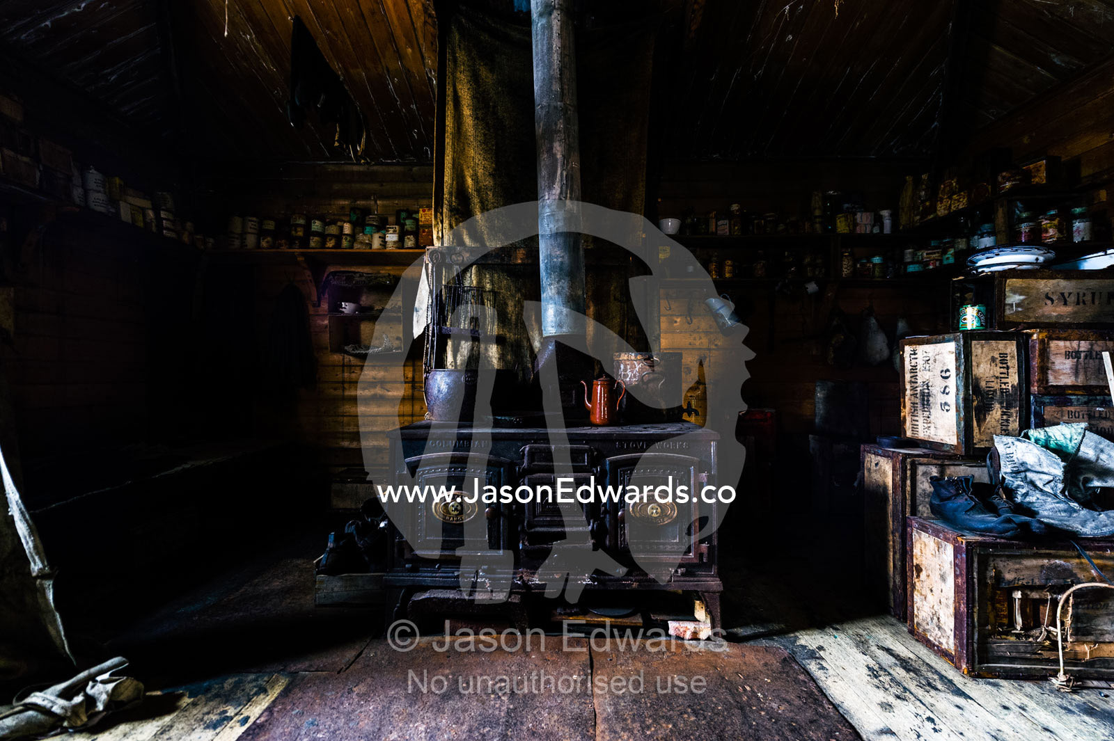The inside of Antarctic explorer Ernest Shackleton's hut with its large stove, food supplies and bed bunks. Shackleton's Hut, Cape Royds, Ross Island, Antarctica.