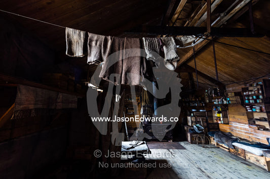Woolen socks hanging from a clothes line above a bunk bed in Antarctic explorer Ernest Shackleton's hut. Shackleton's Hut, Cape Royds, Ross Island, Antarctica.