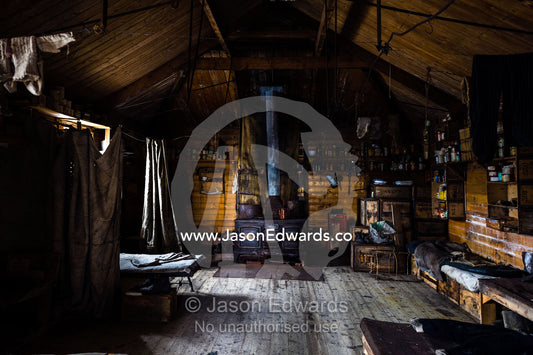 The inside of Antarctic explorer Ernest Shackleton's hut with its large stove, food supplies and bed bunks. Shackleton's Hut, Cape Royds, Ross Island, Antarctica.