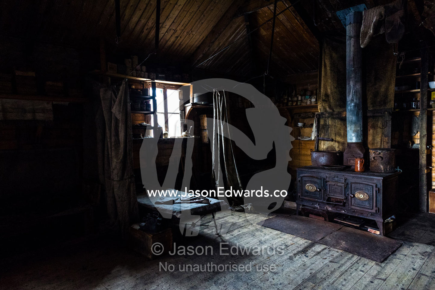 The inside of Antarctic explorer Ernest Shackleton's hut with its large stove, food supplies and bed bunks. Shackleton's Hut, Cape Royds, Ross Island, Antarctica.