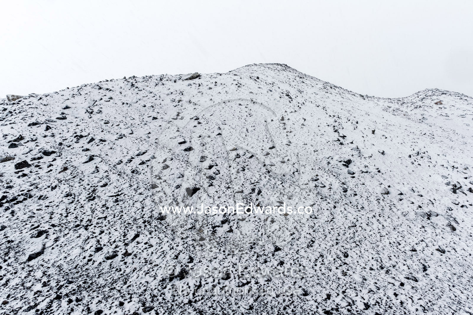 A barren volcanic slope covered in snow during a storm. Cape Bird Ice Cap, Adelie Glacier, Cape Bird, Ross Island, Antarctica