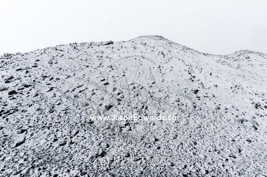 A barren volcanic slope covered in snow during a storm. Cape Bird Ice Cap, Adelie Glacier, Cape Bird, Ross Island, Antarctica